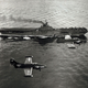 A US Navy Grumman F9F-2B Panther of Fighter Squadron 721 “Starbusters” and a F9F-2P of Composite Squadron 61 “Eyes of the Fleet” return to USS Boxer (CV-21) following a combat mission over Korea in August 1951.